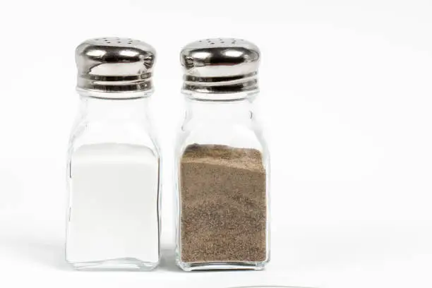 Salt and pepper shaker on white background.