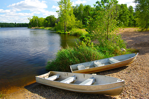 Small fishing boats wait on the shore of a Wisconsin lake.