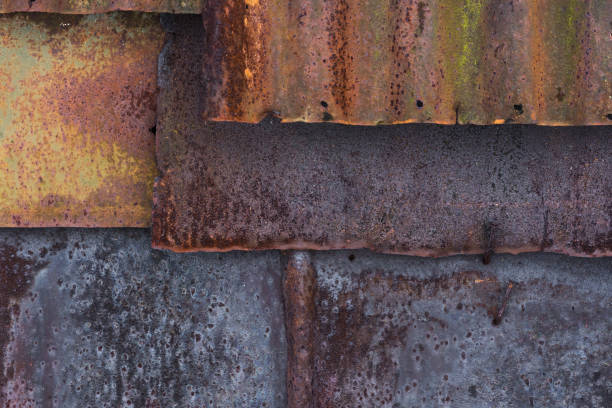 istock The barn wall covered with old rusty tin sheets and slate, background 647430212