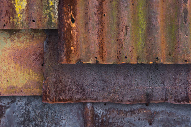 istock The barn wall covered with old rusty tin sheets and slate, background 647430336