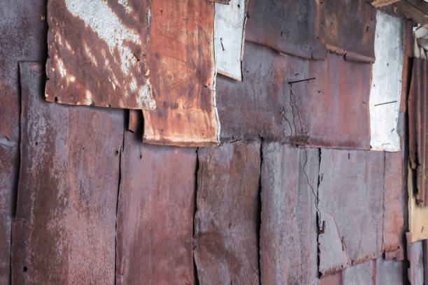 istock Backdrop of the barn covered with old rusty tin sheets and slate, at an angle, background 647430374