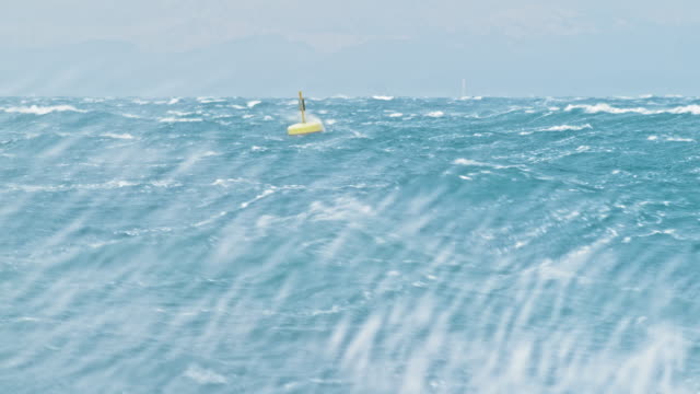 Yellow buoy rocking in the rough sea