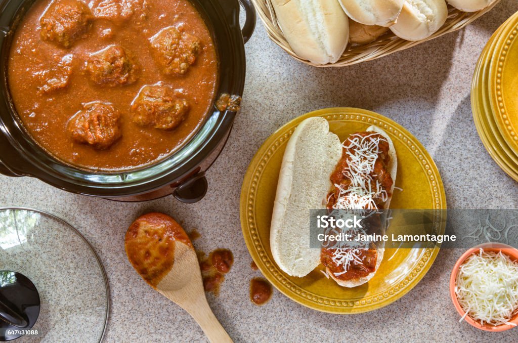 Homemade Meatball Grinder Making meatballs in a crock pot for a home made meatball grinder with mozzarella cheese. Crock Pot Stock Photo