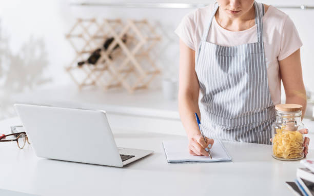 istock Young housewife writing down ingredients 647434344