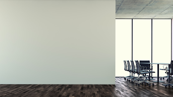 Empty office interior with copy space on blank wall. Conference table with chairs on hardwood floor in front of windows in background. Slight crossprocess effect applied. The furniture is not copied but redesigned on a base of popular executive office chairs.