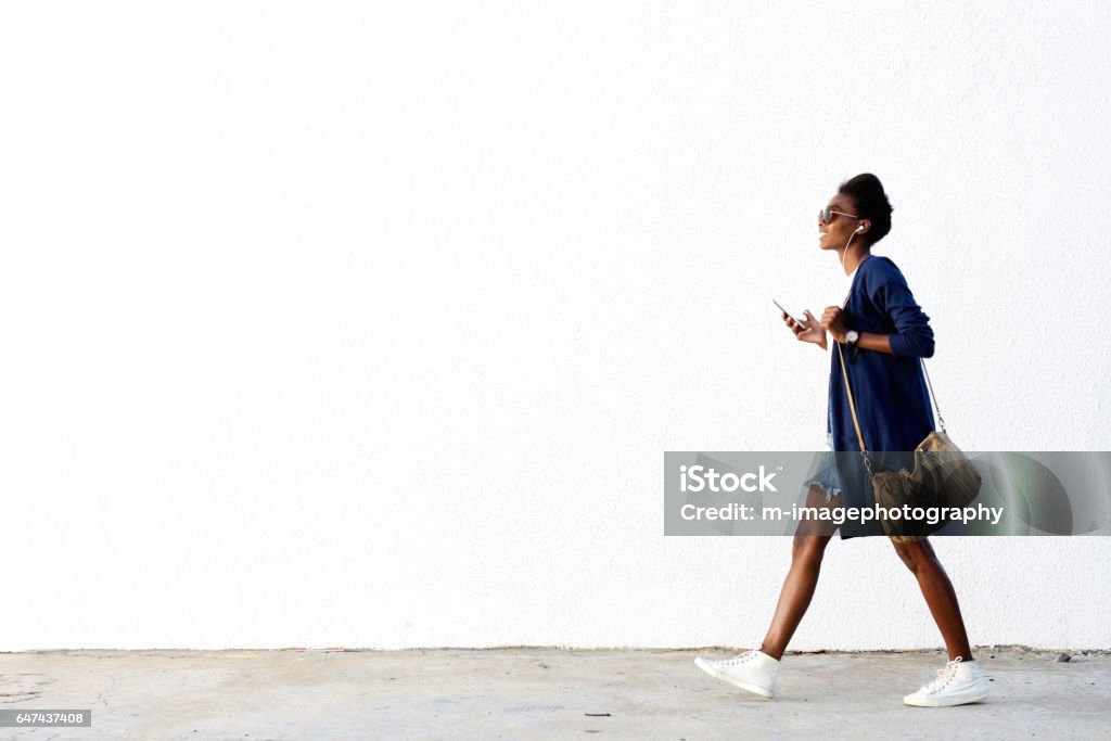 Musique sur téléphone portable dernier cri de femme noire - Photo de Marcher libre de droits