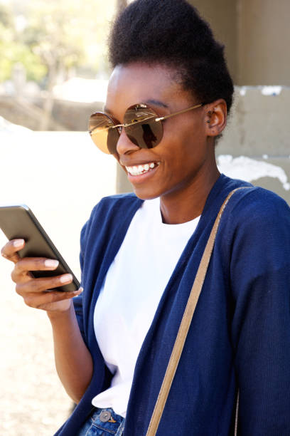 istock Stylish young african woman using mobile phone 647437414
