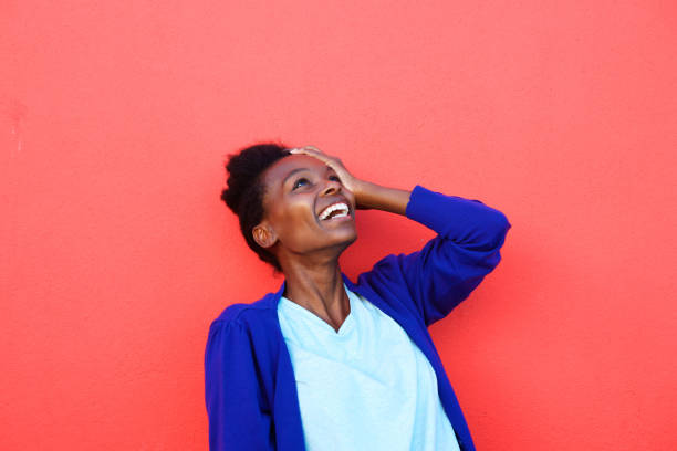 Young african female laughing with her hand on head