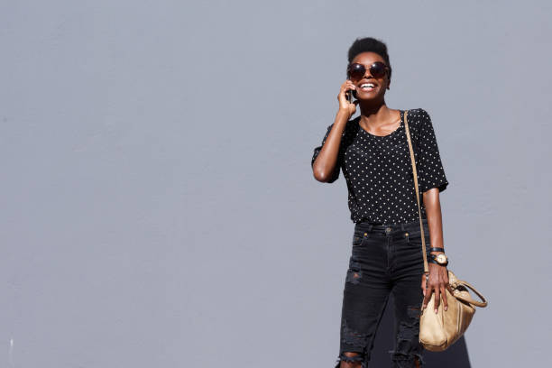 istock Trendy african lady talking on mobile phone 647437506
