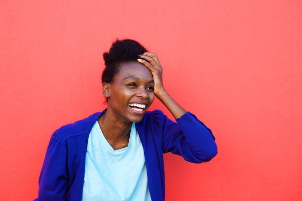 istock Excited young african woman laughing 647437546