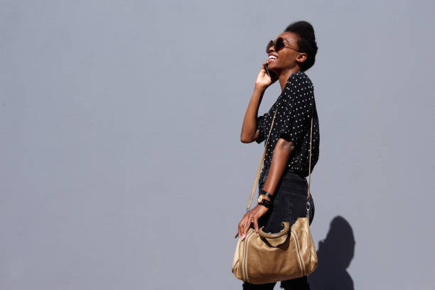 Stylish young afro girl talking on mobile phone