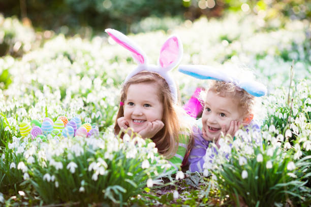 istock Kids on Easter egg hunt in blooming spring garden 647438670