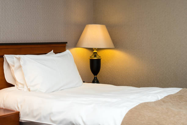 istock two pillows on bed and lamp on wooden table 647441112