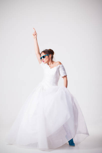 Funny bride with sunglasses dancing stock photo