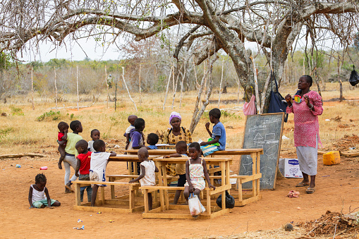 Children from small local village attending open air primary school.