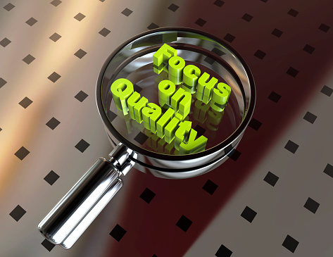 Focus on Quality word in magnifying glass