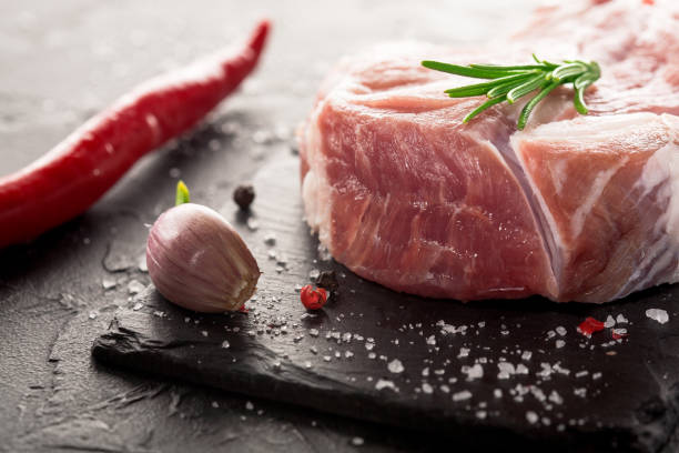 istock pork steak with garlic on a black stone 647455790