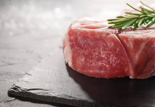 istock pork steak with rosemary on a black stone 647455816