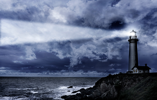 Lighthouse piercing light thru winter storm
