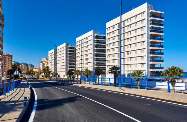 Empty street of La Manga. Spain Empty street of La Manga (La Manga del Mar Menor) is a seaside spit in the Region of Murcia, Spain. january in spanish stock pictures, royalty-free photos & images