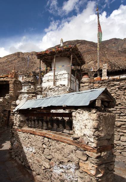istock Stupa and prayer wheels wall in Manang villlage 647460012