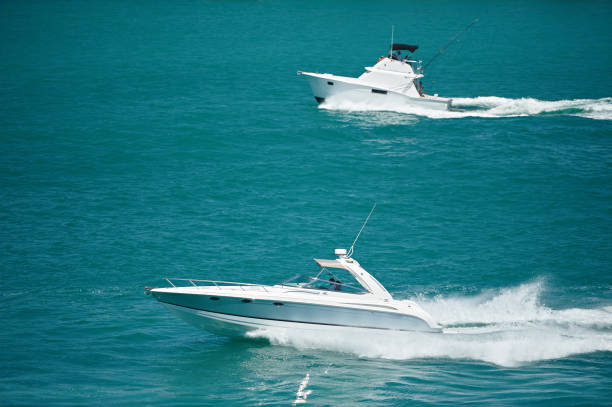 Aerial view of motorboat crossing the sea at high speed next to a ferry