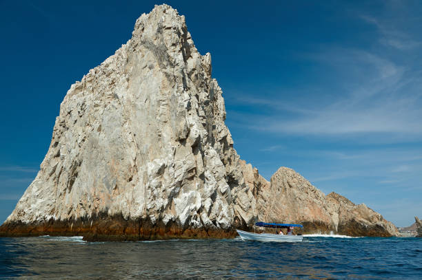 istock Boat close to big rock 647462178