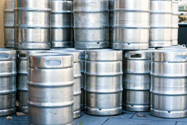 istock Stack of stainless steel beer kegs, background with copy space 647464240