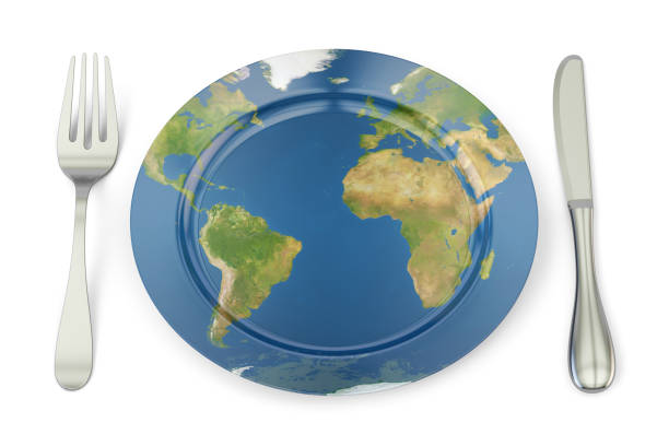 Globe on a plate for food on a pink background. Power, economy, politics, globalism, hunger, poverty and world food concept.