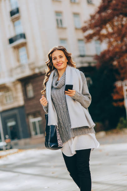 istock Young woman texting outdoors 647467822