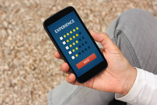 istock Hand holding smart phone with customer review concept on screen 647470596