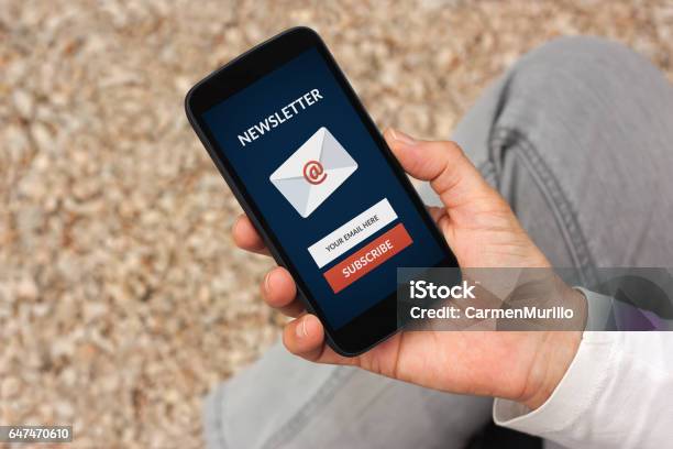 Hand Holding Smart Phone With Subscribe Newsletter Concept On Screen Stock Photo - Download Image Now