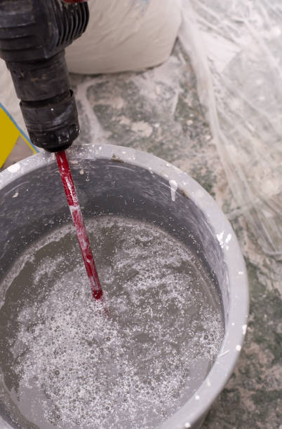 istock Shuffle plaster machine and blender in a plastic bucket. 647473686