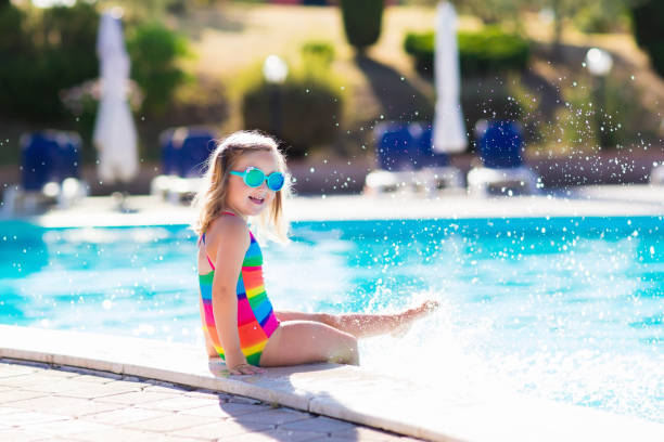 istock Child in swimming pool on summer vacation 647473868