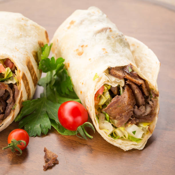 istock Doner kebab on wooden background 647476782