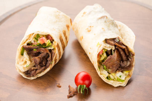 istock Doner kebab on wooden background 647476796