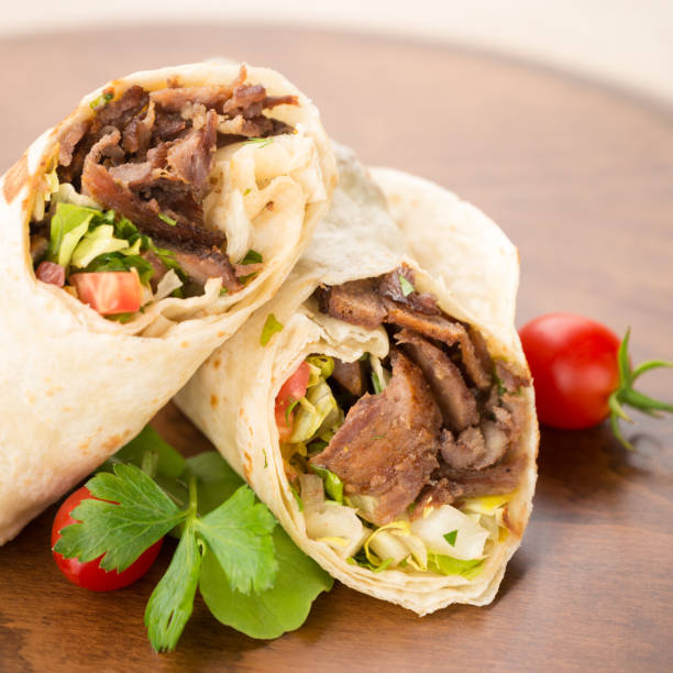 istock Doner kebab on wooden background 647476800