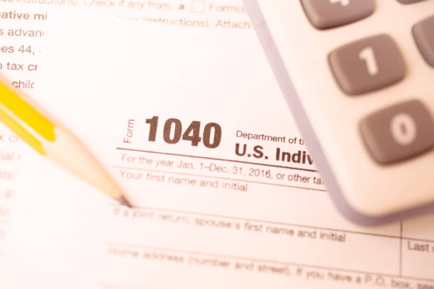 istock Income Tax forms, pencil, calculator close-up view. 647476850