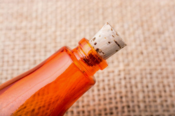 istock Colorful bottle in hand on a linen canvas 647477840