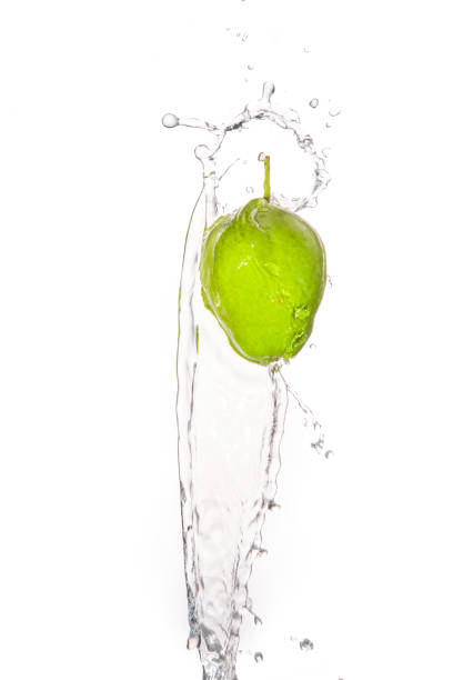 istock Green apple under water with a trail of transparent bubbles. 647478014