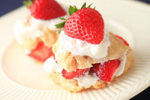 Miniature strawberry shortcakes with whipped cream and fresh berries