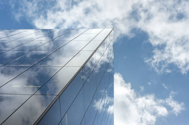 istock Looking up a reflections on glass covered corporate building 647490012