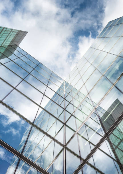 Looking up a reflections on glass covered corporate building