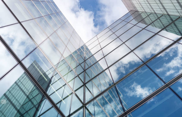 istock Looking up a reflections on glass covered corporate building 647490036