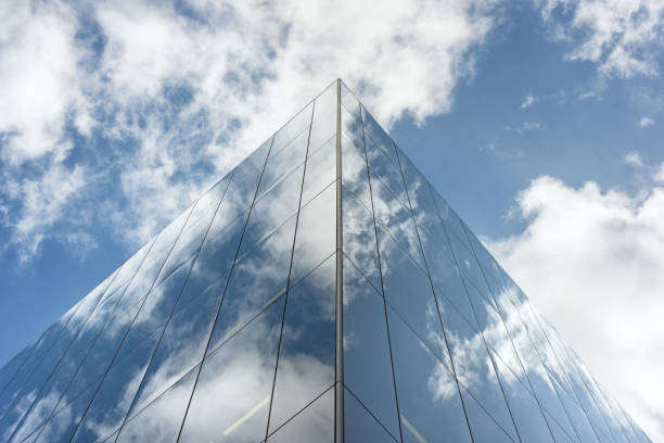 istock Looking up a reflections on glass covered corporate building 647490066