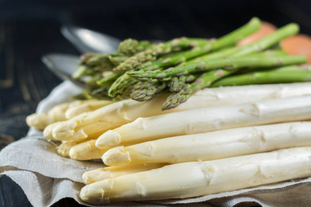 istock Spring season - fresh white and green uncooked asparagus 647490612