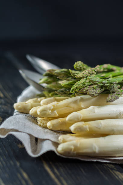 istock Spring season - fresh white and green uncooked asparagus 647490632