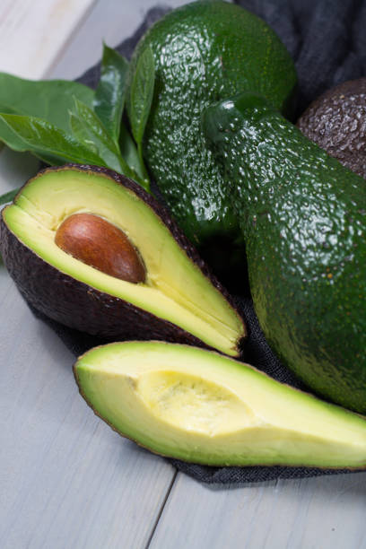 istock Green ripe avocado with leaves 647490746