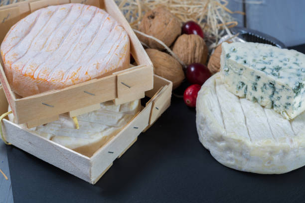 istock Different french soft cheeses on black stone platter 647490770