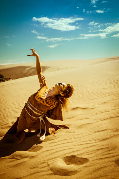 istock Model Wearing Cheetah Makeup Posing The Desert 647494080